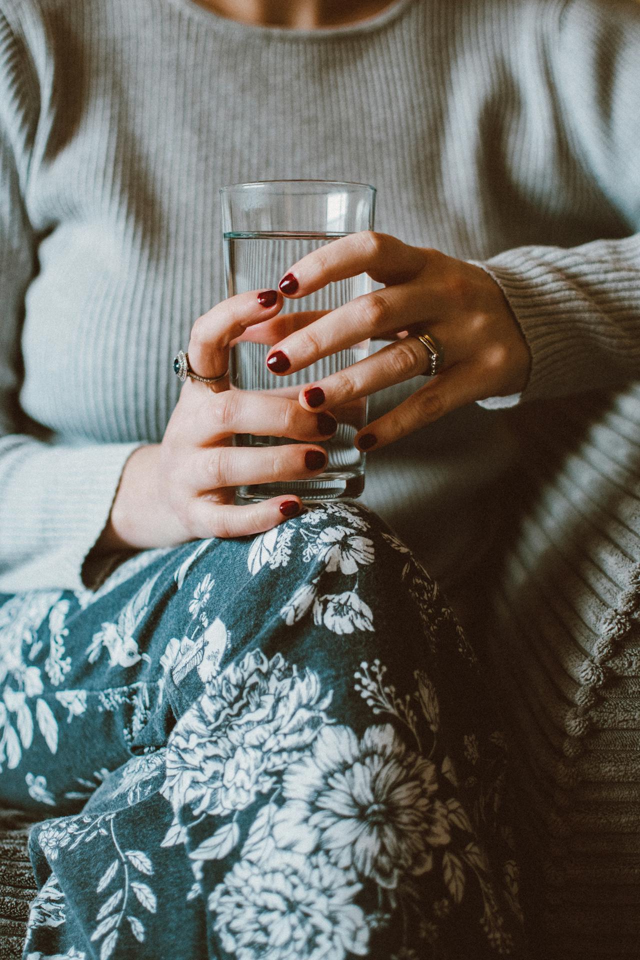 woman holds glass of water